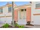 Inviting condo exterior with peach accents, white trim, and manicured landscaping at 7532 Marsh Orchid Cir # 8-201, Bradenton, FL 34203