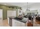 Kitchen breakfast bar overlooking an open-concept living and dining area with hardwood floors at 7532 Marsh Orchid Cir # 8-201, Bradenton, FL 34203