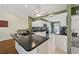 Bright kitchen features white cabinetry, granite countertops, tile flooring, and a central island with sink at 7532 Marsh Orchid Cir # 8-201, Bradenton, FL 34203