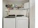 Convenient laundry room is equipped with a washer, dryer and shelves for storage at 7532 Marsh Orchid Cir # 8-201, Bradenton, FL 34203