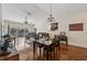 Living and dining area with hardwood floors, ceiling fan, and sliding doors to a balcony at 7532 Marsh Orchid Cir # 8-201, Bradenton, FL 34203