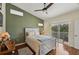 The main bedroom is a large bright space with a ceiling fan and access to an outdoor balcony at 7532 Marsh Orchid Cir # 8-201, Bradenton, FL 34203