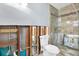 Bathroom featuring a glass-enclosed shower with a tiled backsplash, and updated fixtures at 8421 Flagstone Dr, Tampa, FL 33615