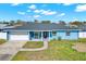 Charming single-story home with attached garage and well-manicured front yard at 8421 Flagstone Dr, Tampa, FL 33615