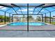 Backyard pool with a screened-in enclosure overlooking the canal at 8421 Flagstone Dr, Tampa, FL 33615