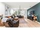 Inviting living room with leather furniture, a statement wall, and ample natural light at 8723 N Calder Pl, Tampa, FL 33604