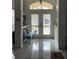 Bright foyer with tile flooring and a view of the front door at 9229 Water Hazard Dr, Hudson, FL 34667