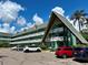 Unique Swiss Alps Chalet building with parking in front and blue skies above at 2042 Australia W Way # 74, Clearwater, FL 33763