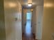 Hallway with laminate flooring leading towards a bright room, and a neutral color paint at 2042 Australia W Way # 74, Clearwater, FL 33763