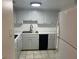 Bright kitchen features white cabinets, a stainless steel sink, and modern appliances at 2042 Australia W Way # 74, Clearwater, FL 33763