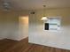 Bright living area featuring laminate flooring, a ceiling fan and a view into the kitchen at 2042 Australia W Way # 74, Clearwater, FL 33763