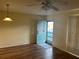 Bright living area featuring laminate flooring, a ceiling fan and a blue exterior door at 2042 Australia W Way # 74, Clearwater, FL 33763