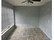 Living room featuring tiled floors, large window, and ceiling fan at 2042 Australia W Way # 74, Clearwater, FL 33763