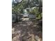 Backyard with wooden sheds and abundant trees at 10120 N Aster Ave, Tampa, FL 33612