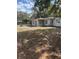 Backyard view of home featuring siding, windows and lawn at 10120 N Aster Ave, Tampa, FL 33612