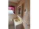 Bathroom featuring a sink with a mirror cabinet and decorative wallpaper at 10120 N Aster Ave, Tampa, FL 33612