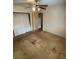 Bedroom featuring a ceiling fan, closet, and doorway to an adjacent room at 10120 N Aster Ave, Tampa, FL 33612