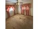 Bedroom featuring pink curtains, a ceiling fan, and worn carpeting at 10120 N Aster Ave, Tampa, FL 33612