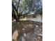 Exterior of a single Gathering home, featuring mature trees providing ample shade and a serene setting at 10120 N Aster Ave, Tampa, FL 33612