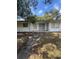 Exterior of a single Gathering home with mature trees and a front porch, offering a warm and inviting appeal at 10120 N Aster Ave, Tampa, FL 33612