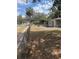 Front yard view of home featuring lawn and fence at 10120 N Aster Ave, Tampa, FL 33612