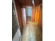 Hallway with multiple doorways and wood paneling at 10120 N Aster Ave, Tampa, FL 33612