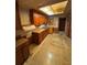 This kitchen features wood cabinets, butcher block countertops and a stainless-steel sink at 10120 N Aster Ave, Tampa, FL 33612