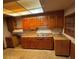 This kitchen features wood cabinets, butcher block countertops and a stainless-steel sink at 10120 N Aster Ave, Tampa, FL 33612