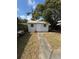 Exterior view of shed with concrete walkway at 10120 N Aster Ave, Tampa, FL 33612