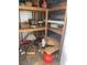 Cluttered shed interior featuring wooden shelving and various stored items at 10120 N Aster Ave, Tampa, FL 33612