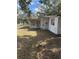 Yard view of home featuring siding, windows and lawn at 10120 N Aster Ave, Tampa, FL 33612