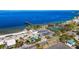 Stunning coastal shot featuring a sandy beach, tennis courts, and a tiki bar by the sea at 1021 Seagrape Dr, Ruskin, FL 33570