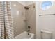 Bathroom boasts tiled shower, bathtub, rain shower head, and a stylish round window at 1021 Seagrape Dr, Ruskin, FL 33570