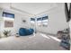 Bright bedroom featuring a cozy blue beanbag chair and large windows with blue valances at 1021 Seagrape Dr, Ruskin, FL 33570