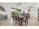 Open dining area with wooden table, seating for eight, sliding doors, and white cabinetry at 1021 Seagrape Dr, Ruskin, FL 33570