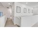 Upper hallway with neutral carpet, recessed lighting, white walls, and three framed art pieces at 1021 Seagrape Dr, Ruskin, FL 33570