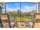 Relaxing screened lanai with comfortable seating overlooking the lush green backyard at 1021 Seagrape Dr, Ruskin, FL 33570