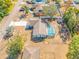 Aerial view of a single Gathering home featuring a screened-in pool, shed, and mature trees at 10261 Horizon Dr, Spring Hill, FL 34608