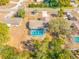 Aerial view of a well-maintained property with a screened-in pool and mature trees at 10261 Horizon Dr, Spring Hill, FL 34608