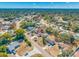 Expansive aerial shot showcasing the property's location within a leafy neighborhood and its proximity to local amenities at 10261 Horizon Dr, Spring Hill, FL 34608