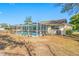 Backyard view of the screened-in pool with lawn, great for outdoor activities at 10261 Horizon Dr, Spring Hill, FL 34608