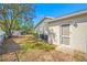 Side yard features a screen door, storage shed, air conditioning unit, and mature trees in the yard at 10261 Horizon Dr, Spring Hill, FL 34608