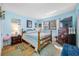 Well-lit bedroom with blue walls and wood flooring at 10261 Horizon Dr, Spring Hill, FL 34608