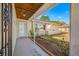 Covered porch with a charming front door and landscaped garden area, creating a cozy and inviting entryway to the home at 10261 Horizon Dr, Spring Hill, FL 34608