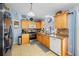 Well-lit kitchen featuring wood cabinets, stainless steel appliances, and tile flooring at 10261 Horizon Dr, Spring Hill, FL 34608