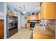 Bright kitchen features stainless steel appliances and ample wood cabinetry at 10261 Horizon Dr, Spring Hill, FL 34608