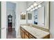 Bathroom with granite countertop, large mirror, and modern light fixtures at 1045 Tracey Ann Loop, Seffner, FL 33584