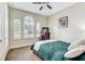 Guest bedroom with a teal bedspread, window shutters and TV at 1045 Tracey Ann Loop, Seffner, FL 33584