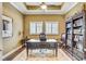 Bright home office with large desk, built-in shelving, hardwood floors at 1045 Tracey Ann Loop, Seffner, FL 33584