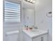 Simple bathroom with single vanity, toilet, and a window with shutters at 11206 Silver Fern Way, Riverview, FL 33569